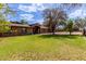 Attractive single-story home featuring a brick exterior, arched entryway, and lush green lawn at 2043 E Quartz St, Mesa, AZ 85213