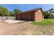 Detached two-car garage with a wide driveway and mature trees at 2043 E Quartz St, Mesa, AZ 85213