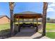 Covered stone gazebo with comfortable outdoor seating and a concrete walkway at 2043 E Quartz St, Mesa, AZ 85213