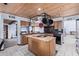 Cozy kitchen featuring tile flooring, wooden cabinets, black appliances, and wood ceiling at 2043 E Quartz St, Mesa, AZ 85213