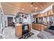 Spacious kitchen features tile flooring, wood cabinetry, and a unique hanging pot rack at 2043 E Quartz St, Mesa, AZ 85213