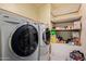 Laundry room featuring full-sized washer and dryer, plus shelving for storage at 2043 E Quartz St, Mesa, AZ 85213