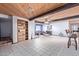 Spacious living area with wood beamed ceiling, tile floors, and built in bookcase at 2043 E Quartz St, Mesa, AZ 85213