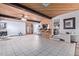 Open living room features wood ceiling, tile flooring, beamed accents, and bar area at 2043 E Quartz St, Mesa, AZ 85213