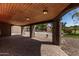 Covered outdoor patio with brick floor and access to the pool area at 2043 E Quartz St, Mesa, AZ 85213