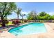 Refreshing in-ground pool surrounded by lush greenery and mature trees with a covered gazebo in the backyard at 2043 E Quartz St, Mesa, AZ 85213