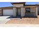 Charming single-story home featuring a brick facade, a driveway, and a well-manicured lawn at 20615 N 226Th Dr, Surprise, AZ 85387