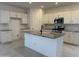 Bright kitchen features white cabinetry, stainless steel appliances, granite countertops and an island with black faucet at 20615 N 226Th Dr, Surprise, AZ 85387