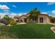 Expansive backyard with lush green grass, mature trees, and a sparkling pool at 22322 N 77Th St, Scottsdale, AZ 85255