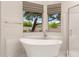 Elegant bathroom featuring soaking tub and bright windows at 22322 N 77Th St, Scottsdale, AZ 85255