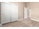 A bedroom featuring a closet, warm paint colors, and neutral plank flooring at 22322 N 77Th St, Scottsdale, AZ 85255