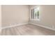 A bedroom featuring a bright sunny window with an outdoor view and neutral plank flooring at 22322 N 77Th St, Scottsdale, AZ 85255