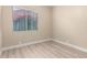A bedroom featuring a bright sunny window with an outdoor view and neutral plank flooring at 22322 N 77Th St, Scottsdale, AZ 85255