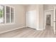 A bedroom featuring a bright sunny window with an outdoor view, closet, and neutral plank flooring at 22322 N 77Th St, Scottsdale, AZ 85255