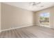 Empty bedroom with hardwood floors and sliding glass door with backyard access at 22322 N 77Th St, Scottsdale, AZ 85255