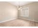 Dining room featuring hardwood floors, plantation shutters, and a decorative chandelier at 22322 N 77Th St, Scottsdale, AZ 85255