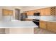 Spacious kitchen boasts updated stainless appliances, stone countertops and wood cabinets at 22322 N 77Th St, Scottsdale, AZ 85255