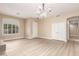 Spacious living room boasts hardwood floors, natural light, and a stylish light fixture at 22322 N 77Th St, Scottsdale, AZ 85255