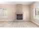 Cozy living room featuring a fireplace with stone accents and natural lighting at 22322 N 77Th St, Scottsdale, AZ 85255