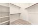 Walk-in closet with shelving and hardwood floors at 22322 N 77Th St, Scottsdale, AZ 85255