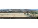 View of the surrounding neighborhood, showcasing nearby houses and the distant mountain range at 22359 W Monona Ln, Surprise, AZ 85387