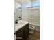 Bathroom featuring a single vanity, mirror, wood cabinets, and shower-tub combo at 22359 W Monona Ln, Surprise, AZ 85387