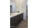 Bathroom featuring dual vanity, mirror, wood cabinets, tile floors, and walk-in shower at 22359 W Monona Ln, Surprise, AZ 85387
