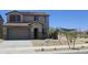 Inviting two-story home featuring a two-car garage, desert landscaping, and a charming entryway at 22359 W Monona Ln, Surprise, AZ 85387