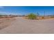 Road leading to a tan single story home on a dirt lot in a rural area at 22819 E Ray Rd, Mesa, AZ 85212