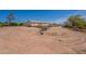 Exterior shot featuring a large dirt lot with sparse vegetation and a home in the background at 22819 E Ray Rd, Mesa, AZ 85212