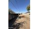 View of the back alley highlighting the property's access and surrounding fencing at 2401 W Weldon Ave, Phoenix, AZ 85015