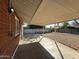 The covered patio for outdoor gatherings, featuring a spacious yard and durable brick construction, adding charm and functionality at 2401 W Weldon Ave, Phoenix, AZ 85015
