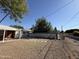 Expansive backyard with mature trees and a secure fence, providing a private and serene outdoor space for relaxation at 2401 W Weldon Ave, Phoenix, AZ 85015