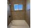 Bathroom shower and tub with nice tile work, as well as a window for natural light at 2401 W Weldon Ave, Phoenix, AZ 85015