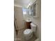 Small bathroom with vanity, toilet, door, and overhead lighting above the mirror at 2401 W Weldon Ave, Phoenix, AZ 85015