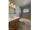 Bathroom with tiled shower over tub and vanity with updated fixtures at 2401 W Weldon Ave, Phoenix, AZ 85015
