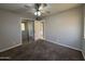 Bedroom with carpet, neutral walls, ceiling fan, and access to other rooms at 2401 W Weldon Ave, Phoenix, AZ 85015