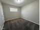 Bedroom with neutral walls, carpet, and a window providing natural light at 2401 W Weldon Ave, Phoenix, AZ 85015