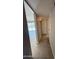 View of the hallway leading into the living room with views through the back patio doors at 2401 W Weldon Ave, Phoenix, AZ 85015