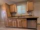 Kitchen featuring wood cabinets, stainless steel appliances, and a double basin sink under a window at 2401 W Weldon Ave, Phoenix, AZ 85015