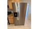 Stainless steel refrigerator with water dispenser complementing the kitchen decor at 2401 W Weldon Ave, Phoenix, AZ 85015