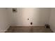 View of the utility room highlighting the tile floors, washer and dryer hookups, and paint cans at 2401 W Weldon Ave, Phoenix, AZ 85015