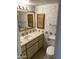Bathroom with a vintage vanity, lighting, and decorative mirror at 2569 W Berridge Ln # D-115, Phoenix, AZ 85017