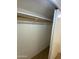 A standard closet with a wooden rod and white shelving at 2569 W Berridge Ln # D-115, Phoenix, AZ 85017