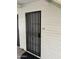 Front door with decorative security door, light brick, and unit number at 2569 W Berridge Ln # D-115, Phoenix, AZ 85017
