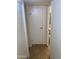 Hallway leading to the bathroom with tile flooring and neutral paint at 2569 W Berridge Ln # D-115, Phoenix, AZ 85017