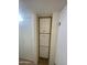 Hallway featuring a narrow, built-in cabinet with multiple doors at 2569 W Berridge Ln # D-115, Phoenix, AZ 85017