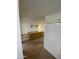 Open-concept kitchen offering wood-look floors, breakfast bar, and wood shelving at 2569 W Berridge Ln # D-115, Phoenix, AZ 85017