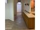 Bright kitchen showcasing wood-look tile flooring, ample countertop space, and convenient access to an arched doorway at 2569 W Berridge Ln # D-115, Phoenix, AZ 85017