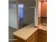 Cozy kitchen displaying ample counter space, wood cabinets and tiled backsplash at 2569 W Berridge Ln # D-115, Phoenix, AZ 85017